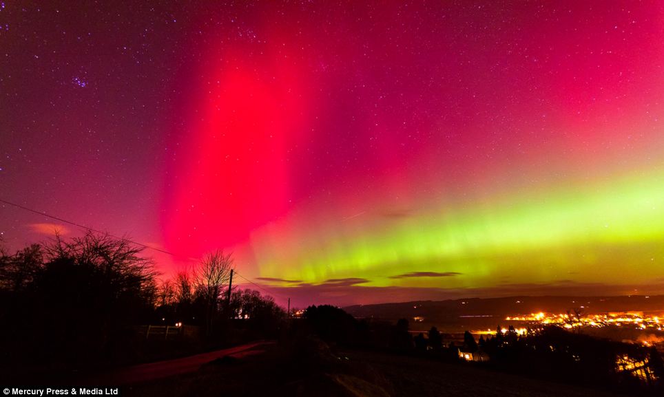 Bright: People across the UK revelled in a rare glimpse of the Northern Lights - stretching as far down as East Anglia. Above, the sky turns pink and yellow