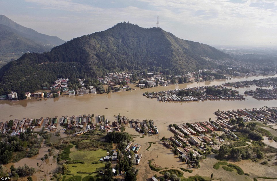 Natural beauty: The Dal Lake in Srinagar. Over the border in Pakistan, authorities were considering blowing up strategic dykes to divert the ceaseless flow of water