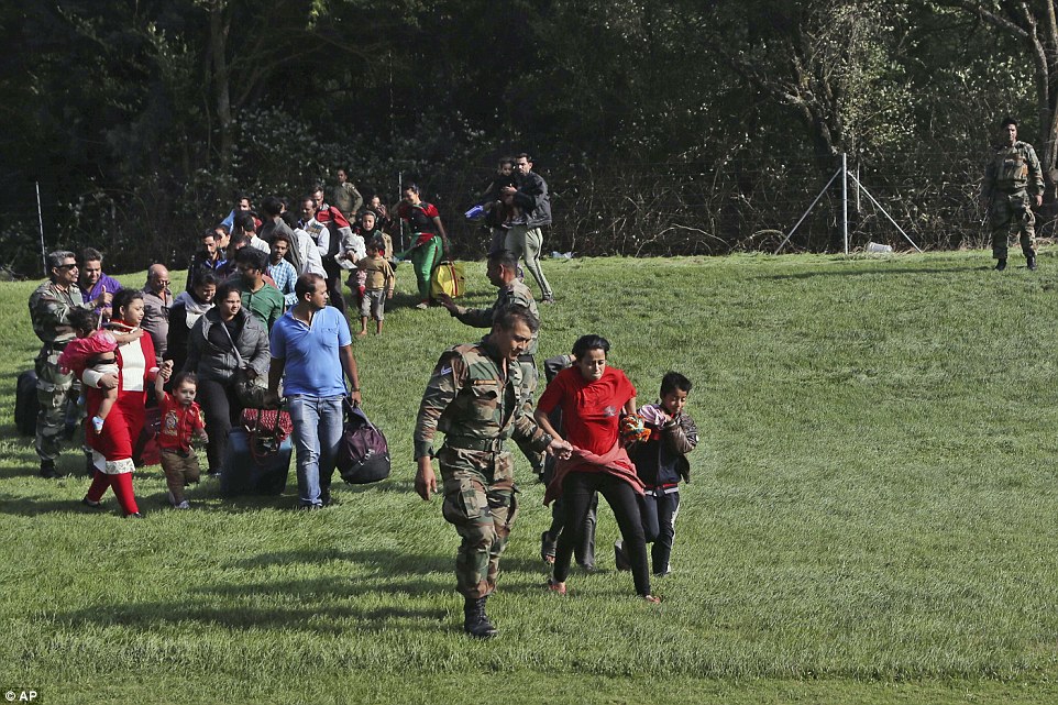 Holiday cut short: Tourists were rescued from flooded areas of Srinagar and put on an Indian air force helicopter today as thousands more remained stranded