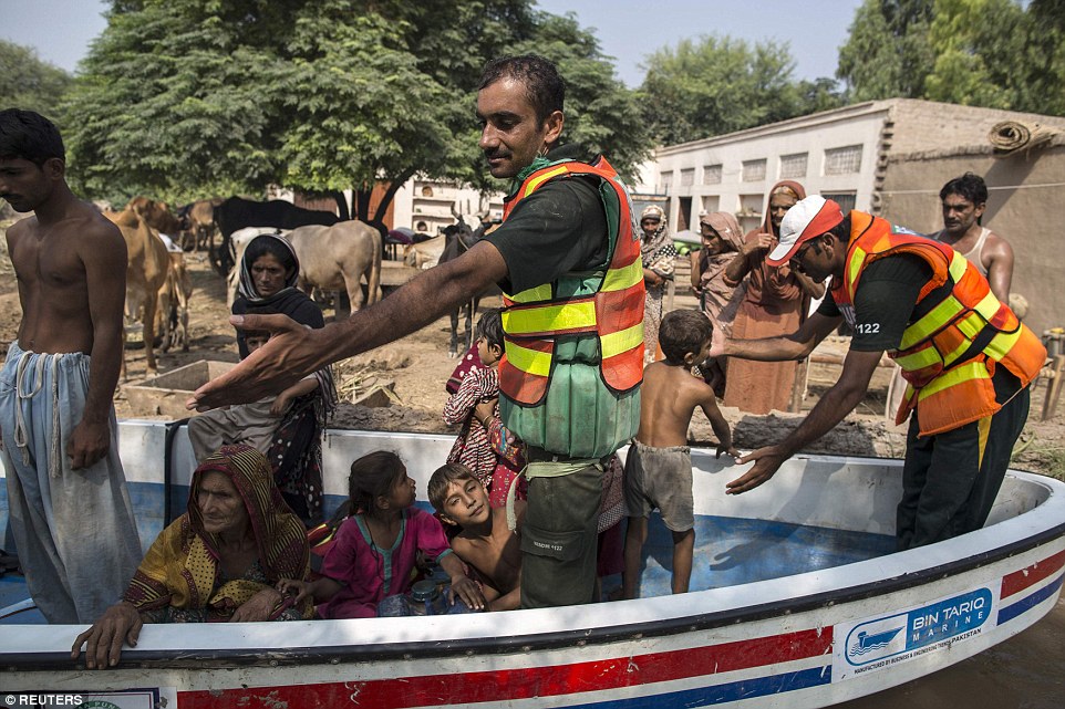 Over the border: In Punjab province, Pakistan, the flooding was just as severe. Each nation has pledged to help the other recover despite wars over Kashmir in the past