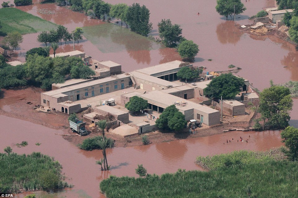 Dirty: Officials fear the sudden deluge will spread water-borne diseases such as diaorrhea if urgent sanitation measures are not put in place soon