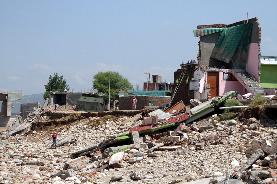 Rubble: Survivors in Indian Kashmir's winter capital Jammu were dwarfed by their damaged houses today as authorities vowed to speed up the rescue effort