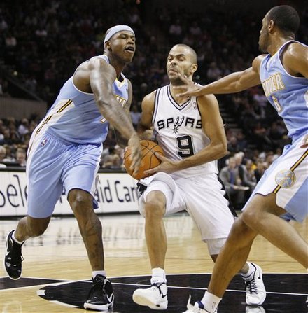 San Antonio Spurs' Tony Parker, Center, Of France, Is Fouled As He Drives Between Denver Nuggets' Al Harrington, Left,