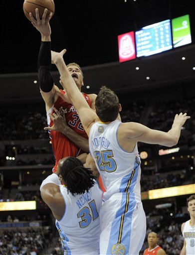 Los Angeles Clippers Forward Blake Griffin (32) Goes Up For A Shot Against Denver Nuggets Center Nene (31) From Brazil