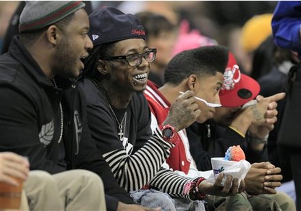 Musician Lil Wayne, Second From Left, Watches
