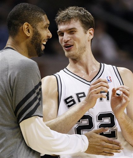 San Antonio Spurs' Tim Duncan, Left, And Tiago Splitter, Of Brazil, Talk