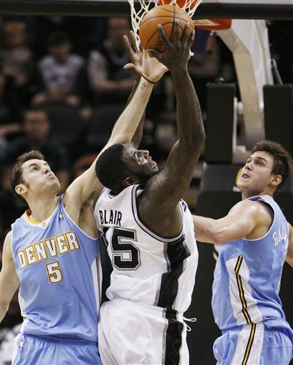 San Antonio Spurs' DeJuan Blair, Center, Shoots Over Denver Nuggets' Rudy Fernandez, Left, Of Spain, And Danilo