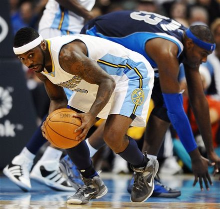 Denver Nuggets Guard Ty Lawson, Left, Grabs