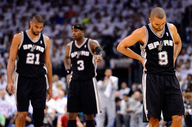 Tony Parker #9, Tim Duncan #21 And Stephen Jackson #3 Of The San Antonio Spurs Walk Down Court Against The Oklahoma