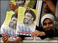 Displaced Lebanese children returning home display posters of Hezbollah leader Sheikh Hassan Nassrallah, 14 August 2006