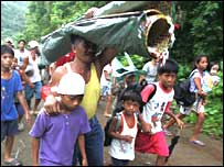 People leave a Philippines village as part of the tsunami drill