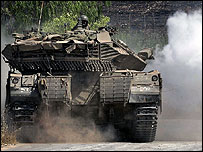 An Israeli tank manoeuvres in the Israeli area of Avivim, on its border with Lebanon