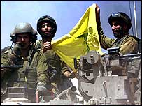 Israeli soldiers with a Hezbollah flag