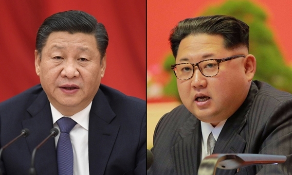 Chủ tịch Trung Quốc Tập Cận Bình (trái) và nhà lãnh đạo Triều Tiên Kim Jong-un. Ảnh: China Daily/Reuters.