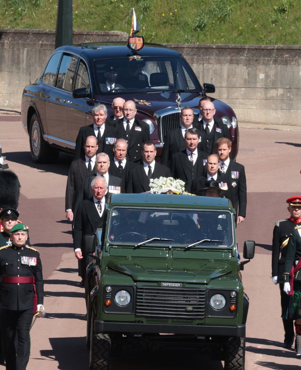 Queen Elizabeth in the Bentley State Limousine and members of the Royal Family follow the hearse during the funeral of Britain's Prince Philip, who died at the age of 99, data-on the grounds of Windsor Castle in Windsor, Britain, April 17, 2021.