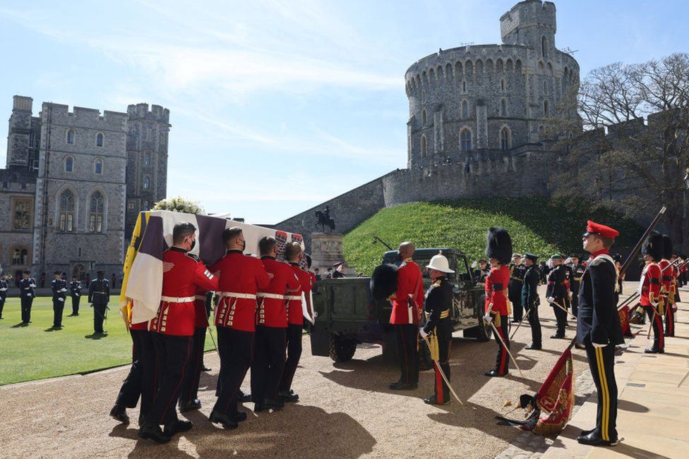 The Duke of Edinburgh's coffin, covered with His Royal Highness's Personal Standard is carried to the purpose built Land Rover during the funeral of Prince Philip, Duke of Edinburgh at Windsor Castle data-on April 17, 2021 in Windsor, England.