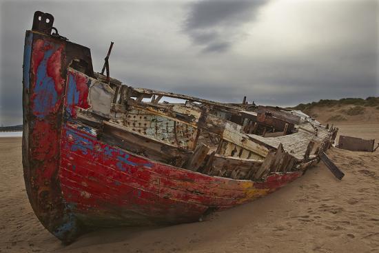 A Wrecked Boat Lying Among Sand Dunes Photographic Print by Nigel ...