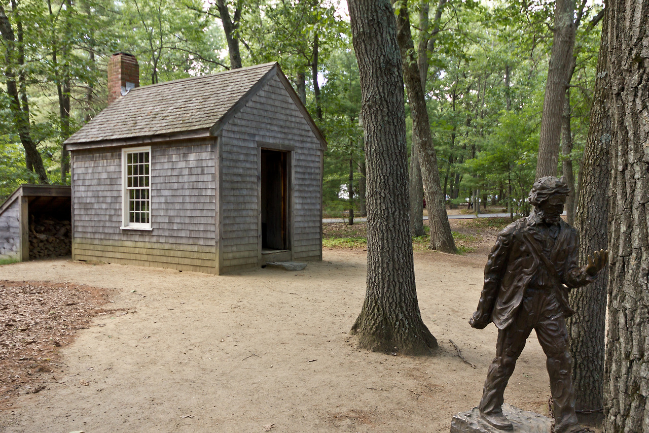 Replica_of_Thoreau's_cabin_near_Walden_Pond_and_his_statue.jpg