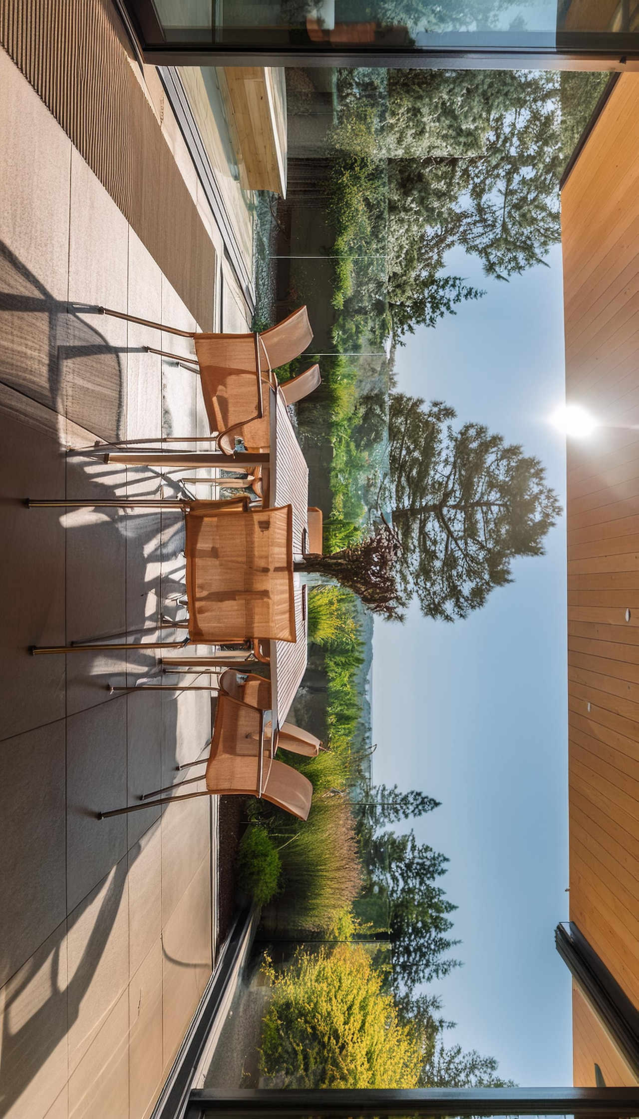 Firefly A patio table with four chairs, positioned adjacent to large floor-to-ceiling glass sliding  (2).jpg