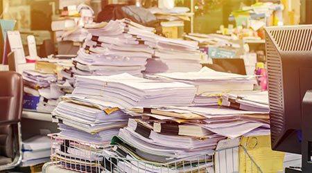 documents-stacked-high-on-desk-22297.jpg
