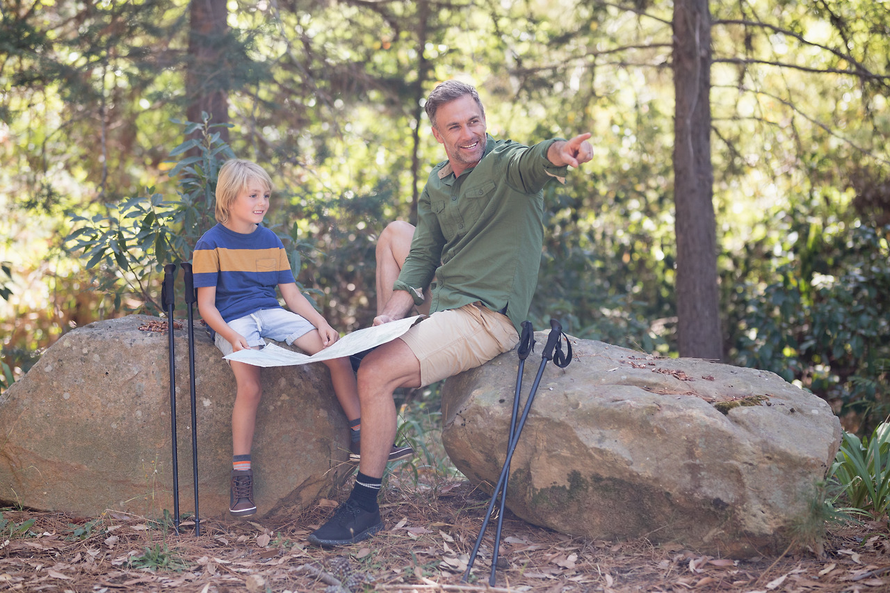 father-showing-direction-to-son-in-forest-23P6Y75.jpg