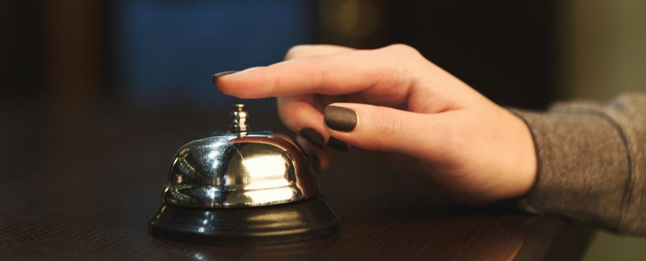 woman-ringing-hotel-reception-service-bell-closeup-P96GPQP.jpg