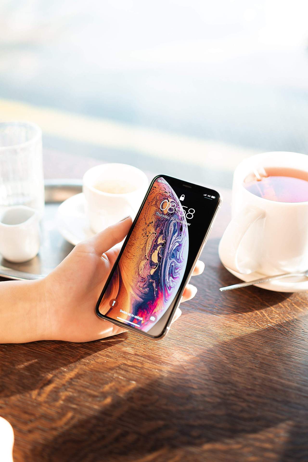 showing-an-iphone-xs-in-cafe-2210x3315.jpg