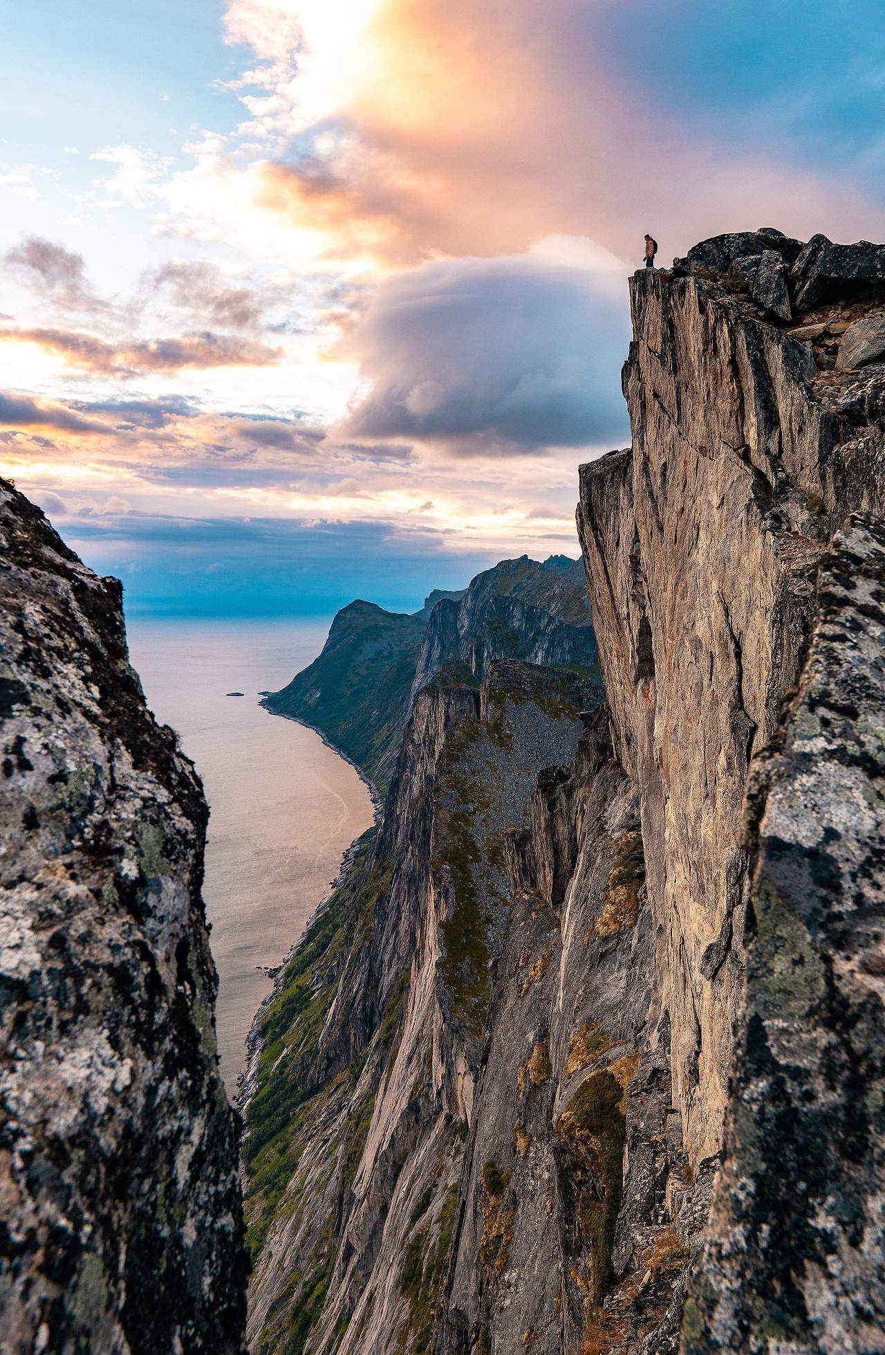 man-standing-on-the-edge-of-the-cliff-on-senja-island-2210x3381.jpg