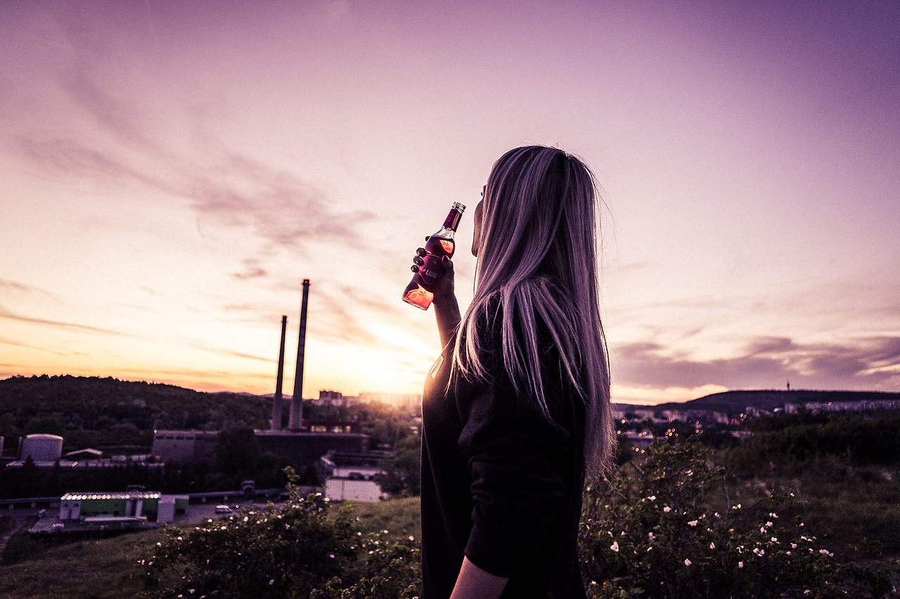 young-woman-enjoying-a-drink-in-sunset-2210x1473.jpg