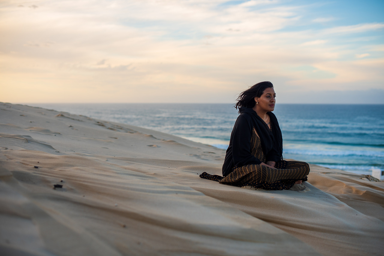 woman-seen-sitting-on-sand-dune-while-watching-the-2023-11-27-04-53-55-utc.jpg