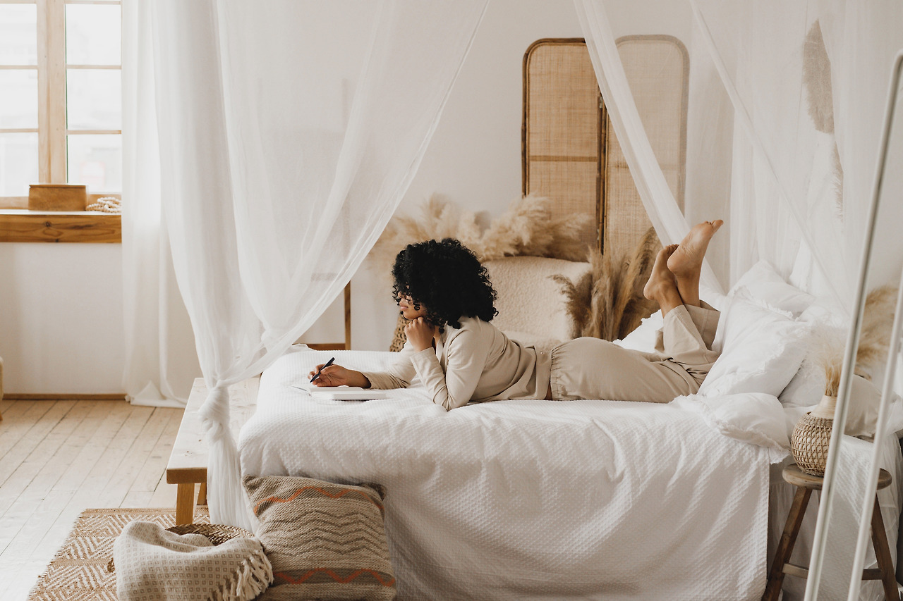 young-african-american-woman-journaling-in-bed-2024-12-04-19-22-35-utc.jpg