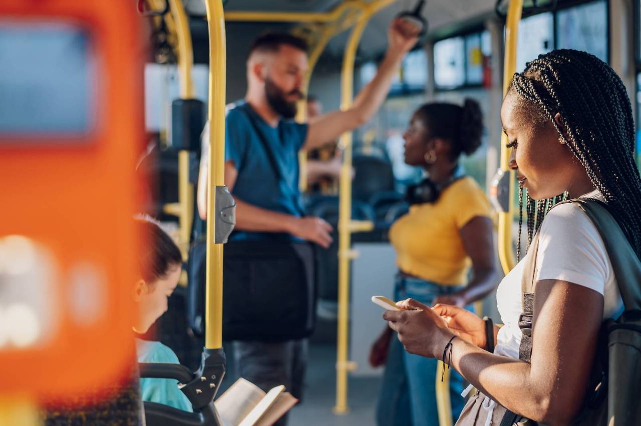 african-american-woman-riding-in-a-bus-and-using-a-2023-11-27-05-30-08-utc (1).jpg