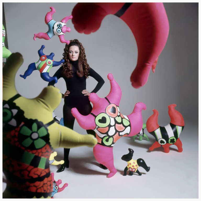 Niki de Saint-Phalle standing among her sculptures. April 1968.jpg
