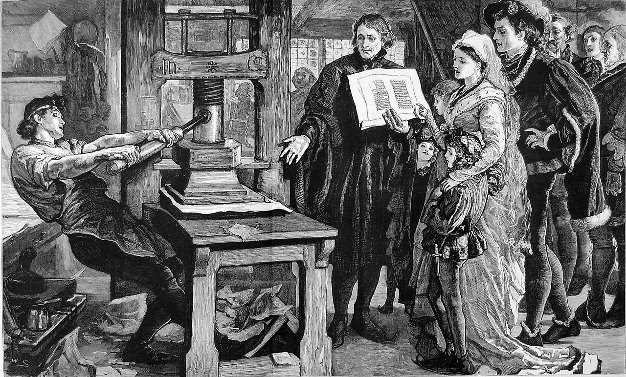 1920px-The_Caxton_Celebration_-_William_Caxton_showing_specimens_of_his_printing_to_King_Edward_IV_and_his_Queen.jpg