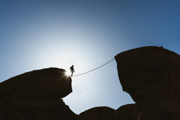 challenge-risk-concentration-bravery-concept-silhouette-man-balance-walking-rope-precipice_123766-7.jpg