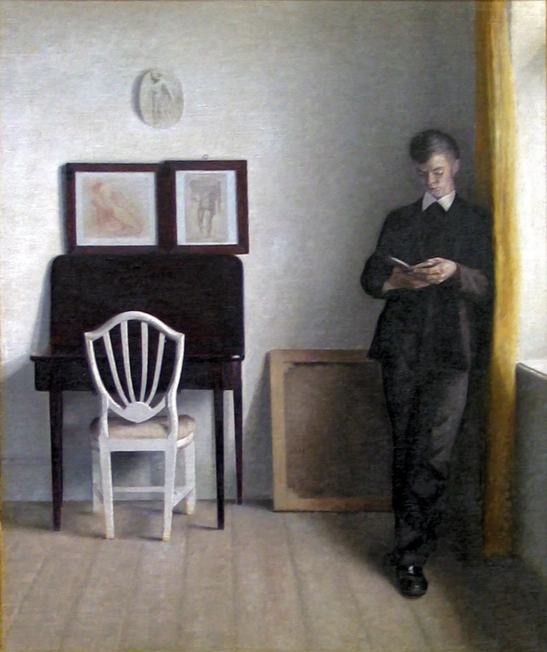 hammershoi-vilhelm---interior-med-laesende-ung-mand_19990973215_o.jpg