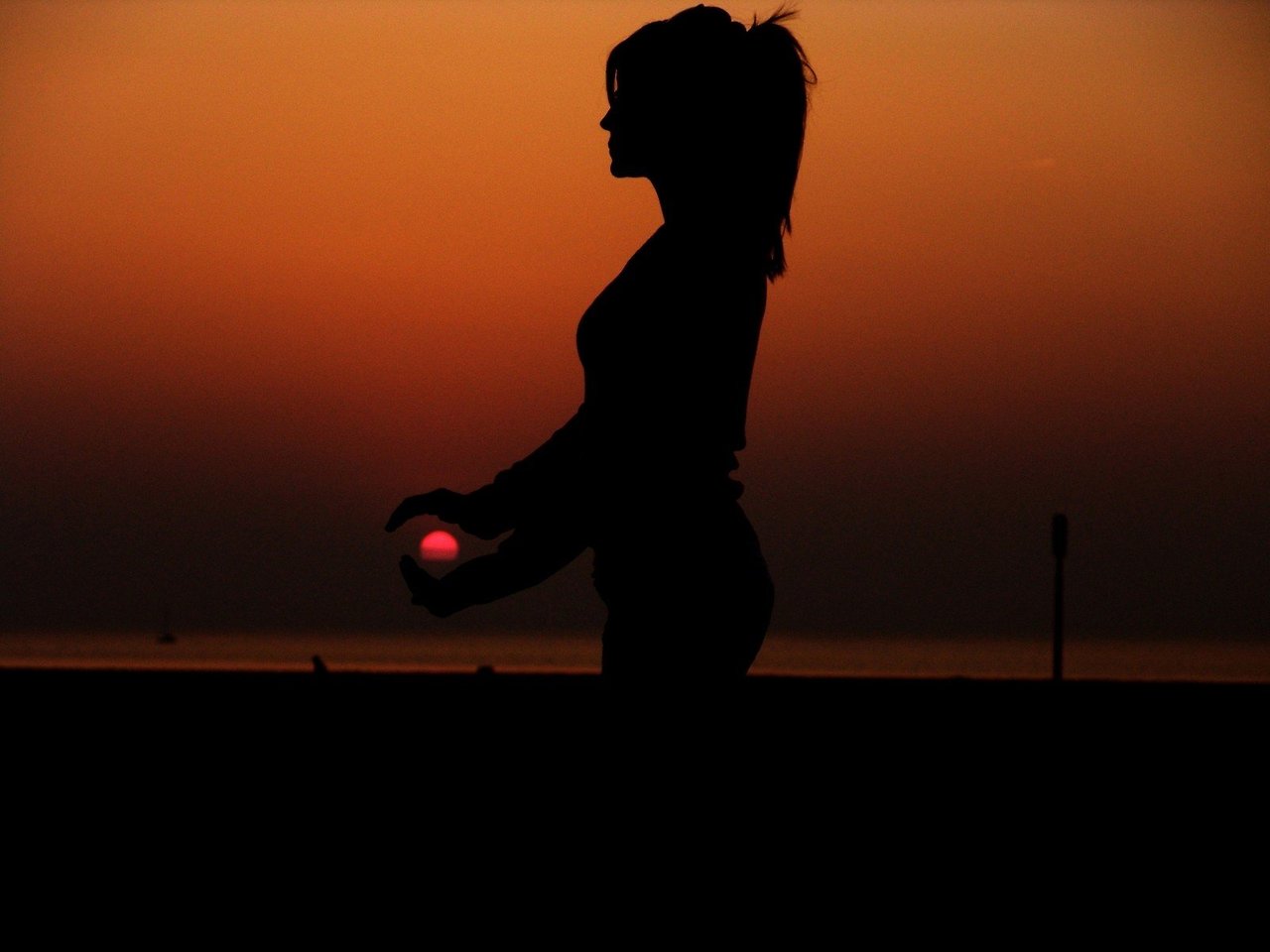 silhouette-of-young-woman-embracing-sun-at-sunset.jpg