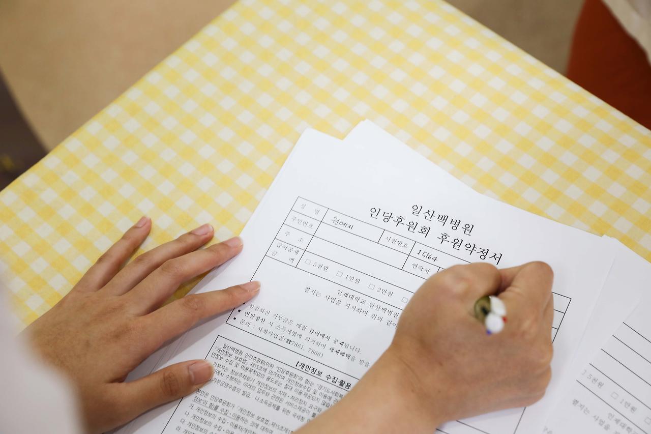 [사진3]일산백병원 교직원이 인당후원회 신청서를 작성하고 있다.jpg