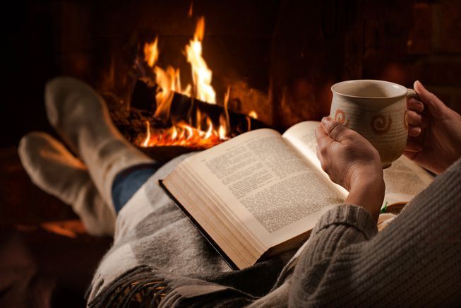 woman_sipping_chocolate_reading_book_fireplace.jpg.653x0_q80_crop-smart.jpg