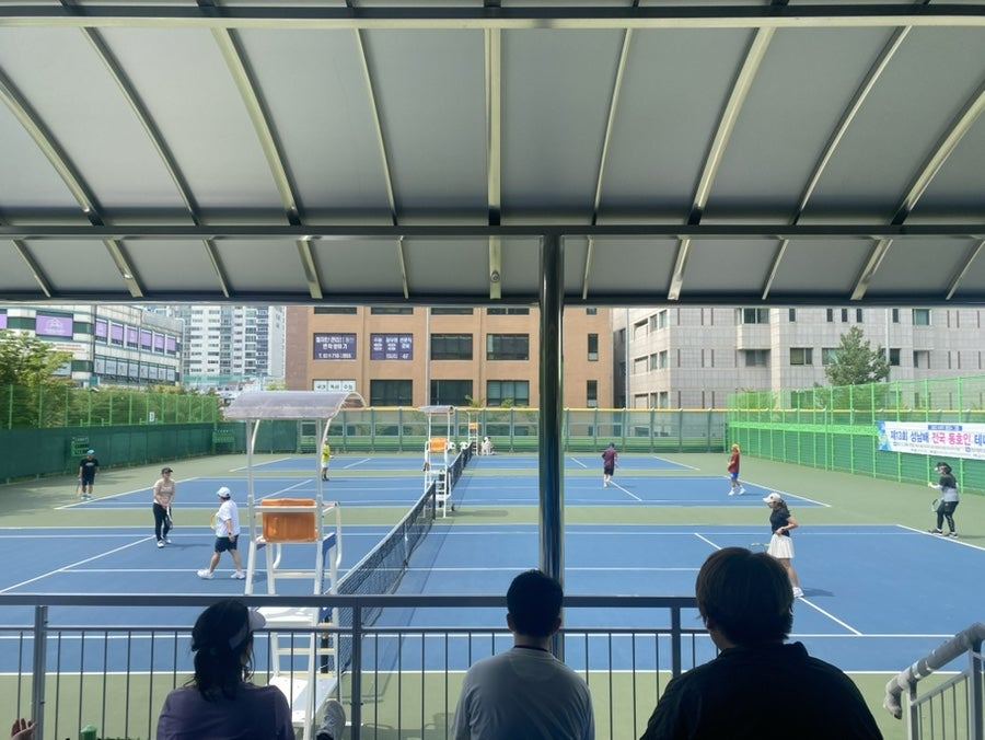 Tennis court with players in action