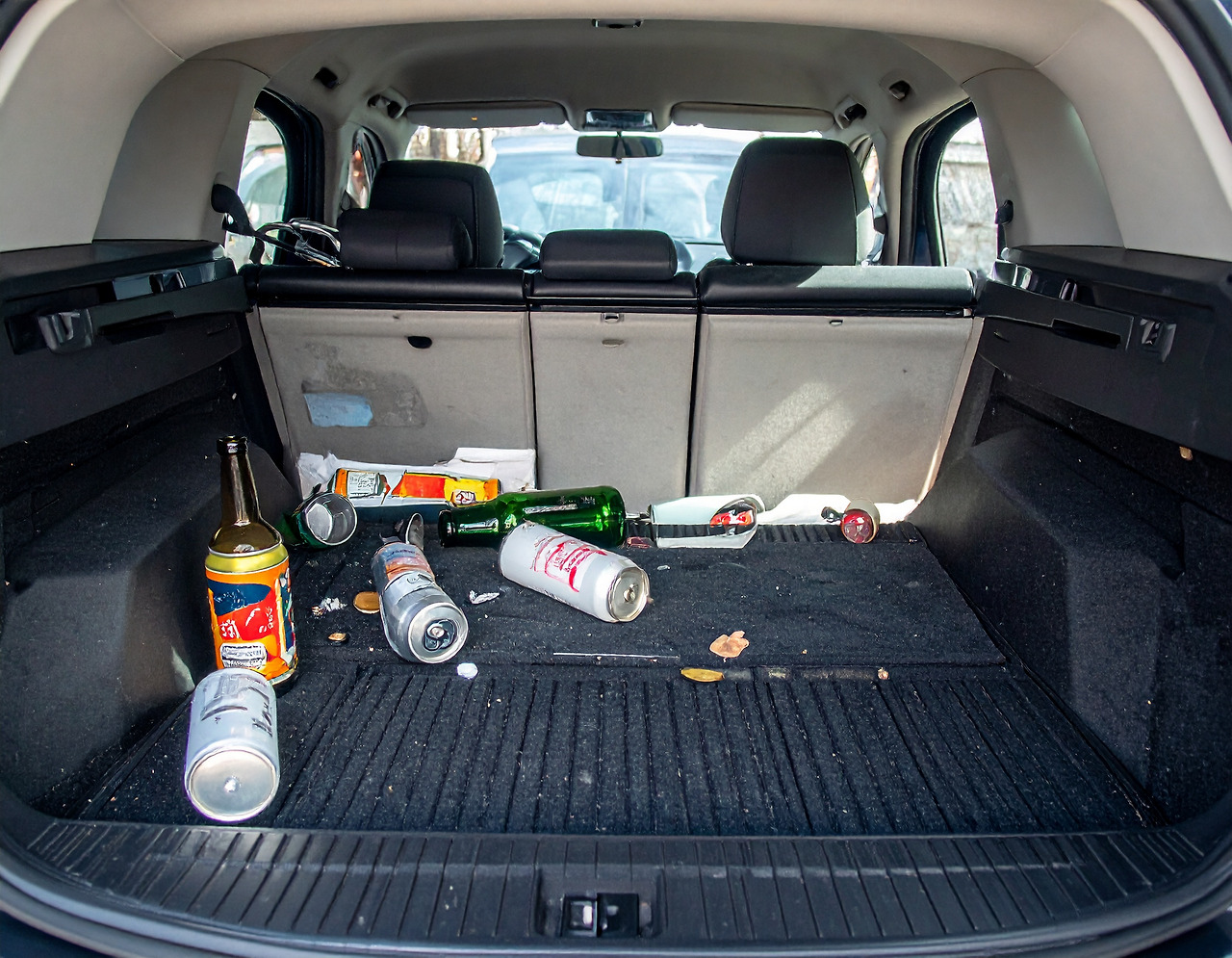 Firefly_Beer cans and soju bottle were strewn across the back trunk of an SUV with the door o 860455.jpg