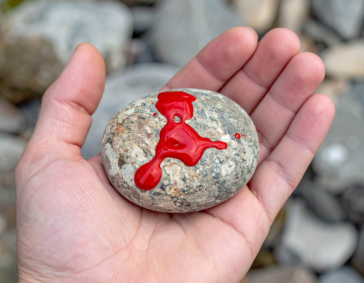 Firefly Someone is holding a stone with red ink in one hand. 397581.jpg