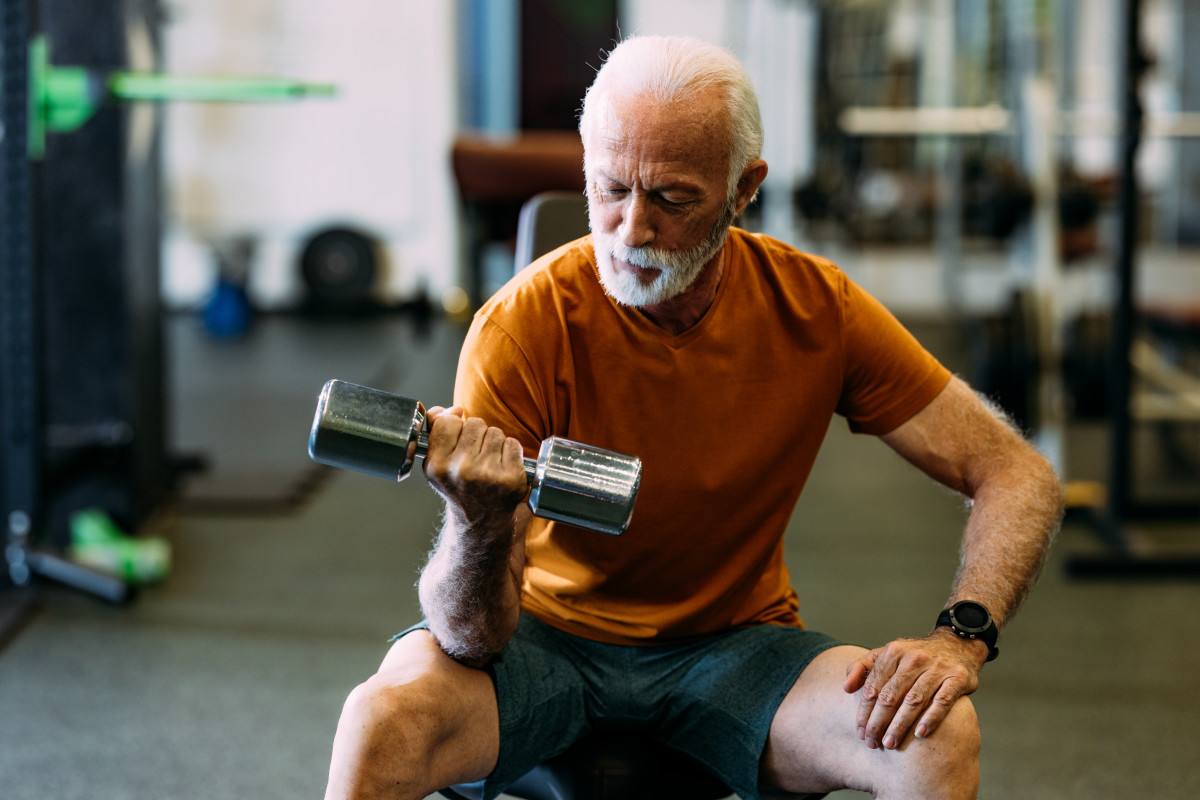 senior-man-working-out-with-dumbbells-in-gym.jpg