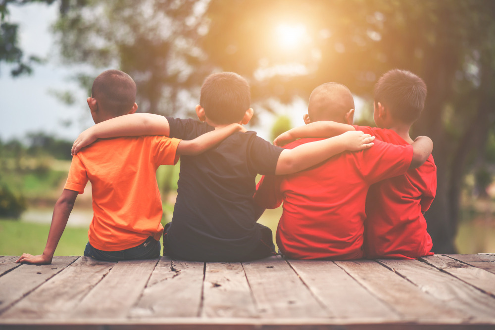 group-of-kids-friends-arm-around-sitting-together.jpg
