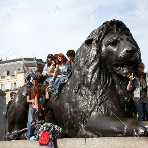 13580860-london-uk-august-19-2010-tourist-with-lion-statue-in-trafalgar-square-london-trafalgar-square-is-one.jpg