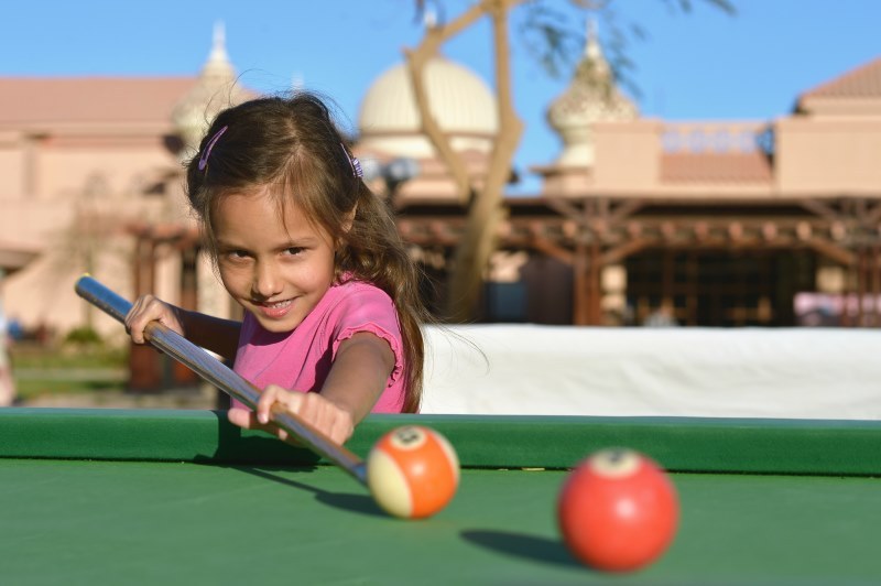 girl-playing-on-mini-pool-table-for-kids.jpg