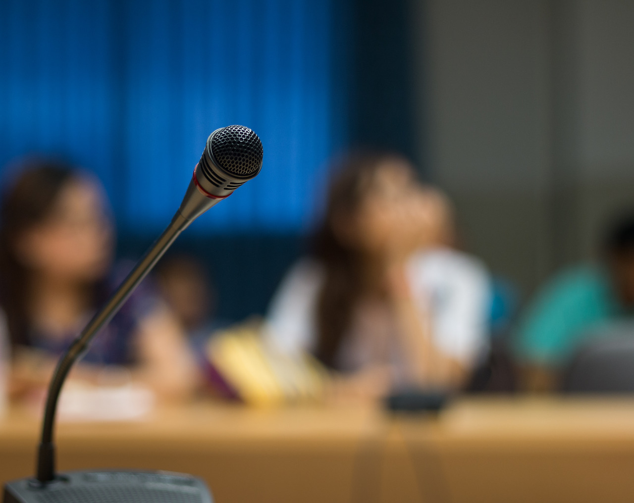 vecteezy_soft-focus-of-microphone-in-conference-room_1343661.jpg