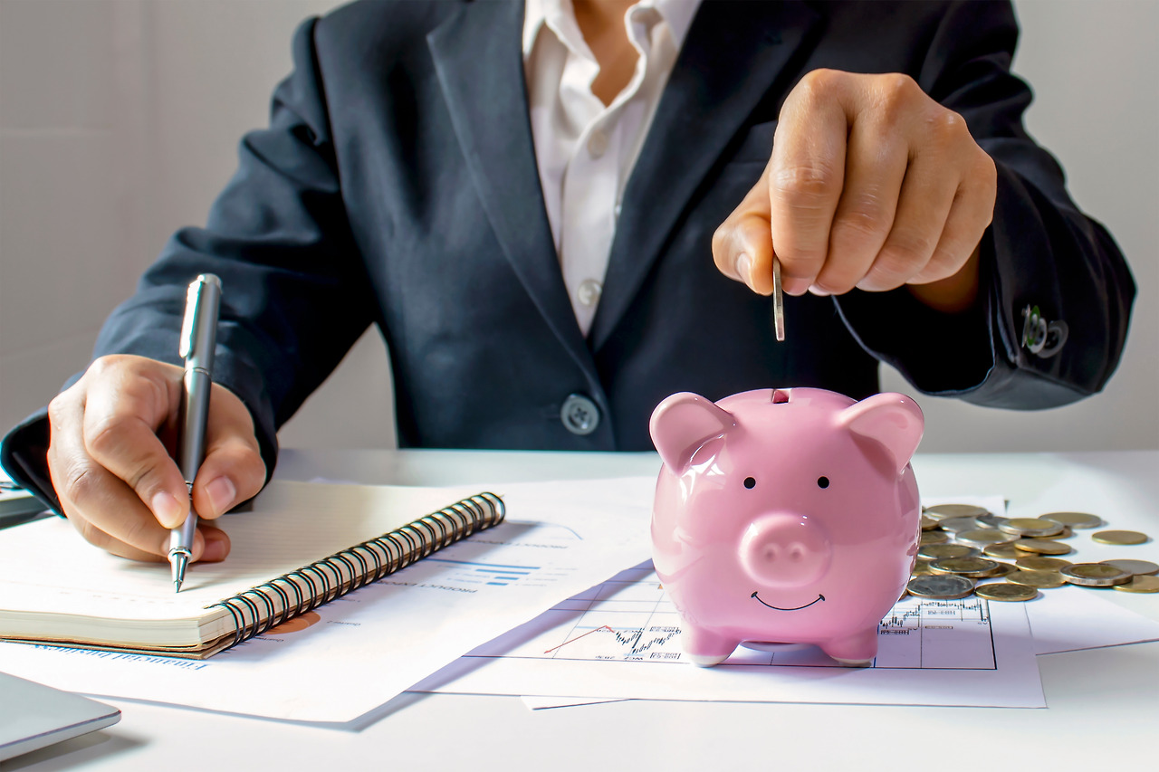 vecteezy_professional-putting-money-in-piggy-bank_1905653.jpg