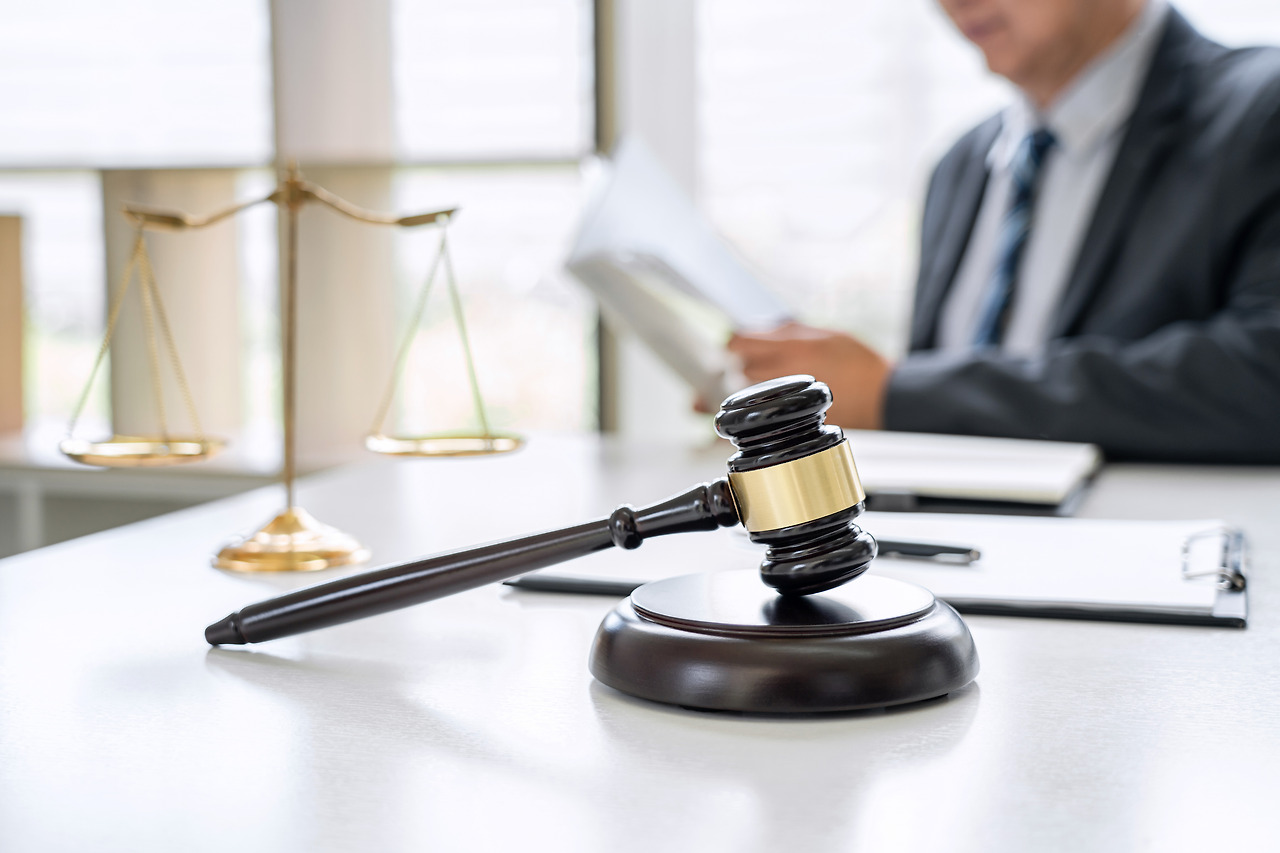 vecteezy_lawyer-working-on-a-documents-in-courtroom_1309420 (1).jpg