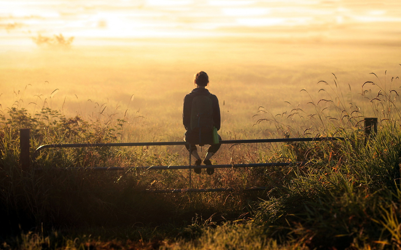 girl-backpack-thinking-sunset-field-fence-.jpg